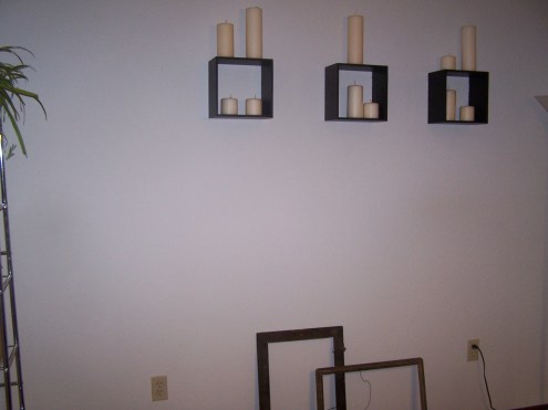 This is the wall behind the dining table.  It is pretty bare for right now, but we are working on redoing a giant antique desk for this spot.  We got the desk at an auction for $5!  The candles and shelves will stay. 