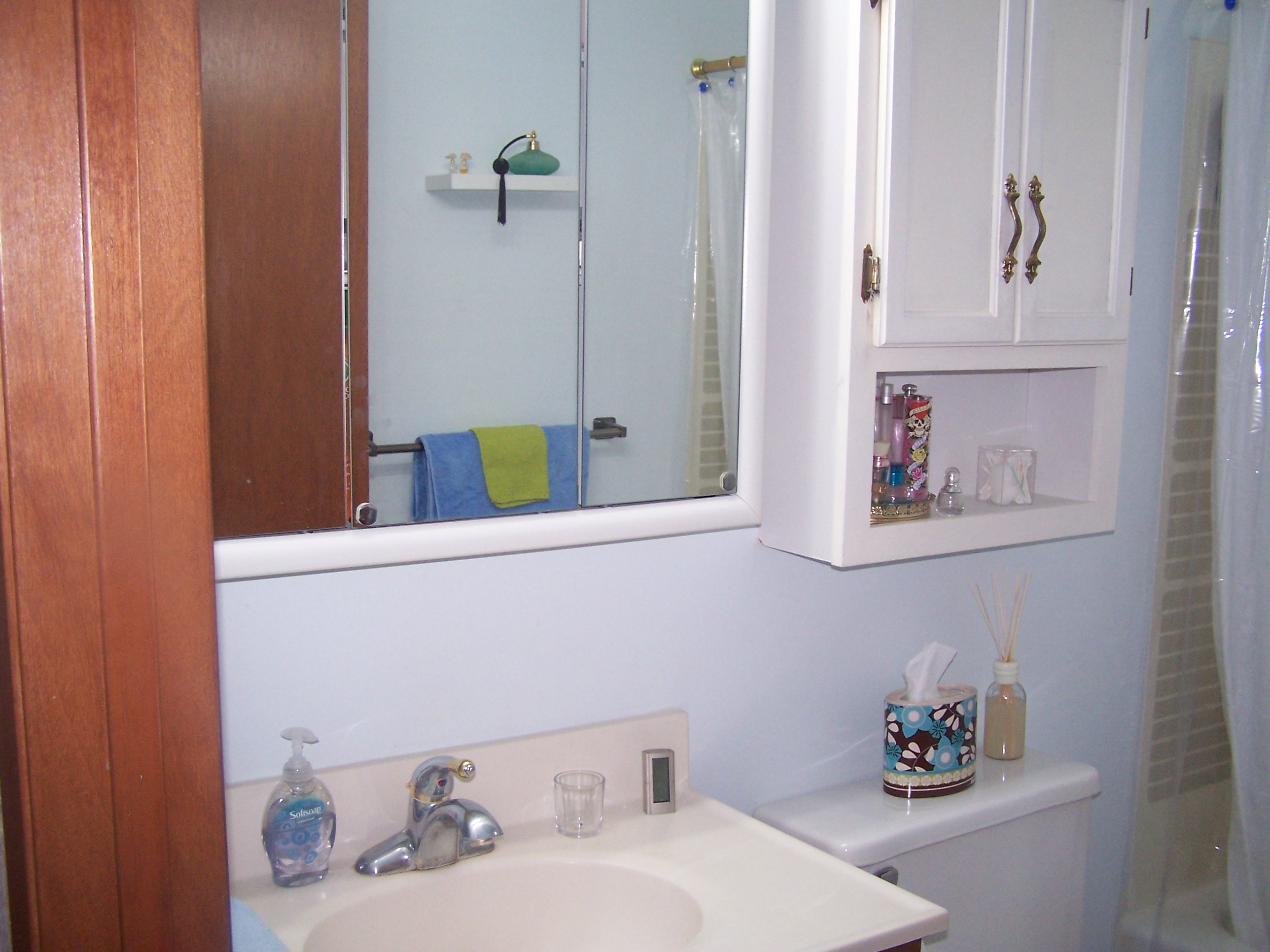 Close up of sink and storage.  Pretty much the entire bathroom.