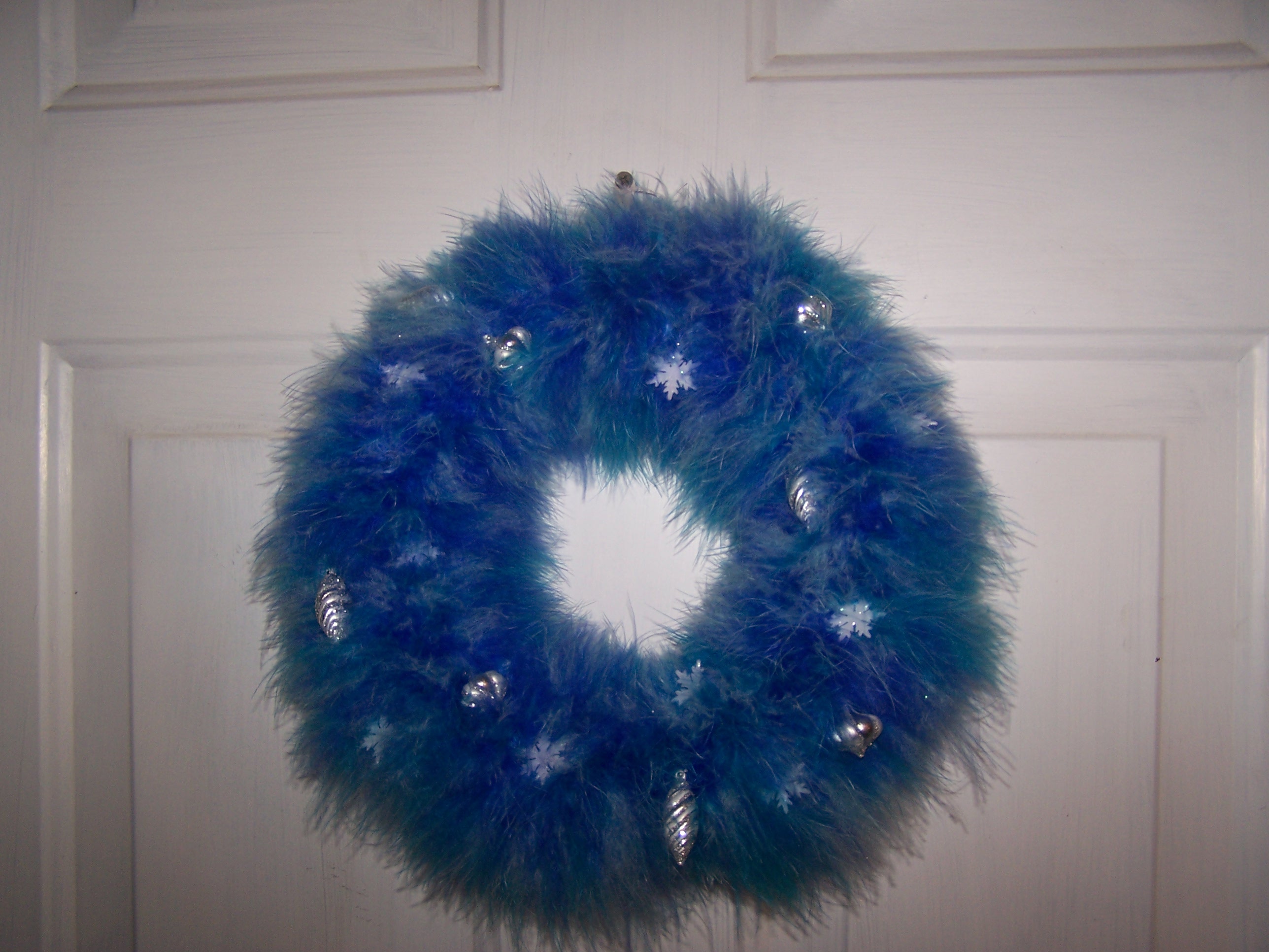 The wreath. I made this with a foam wreath and 2 boas. Then pinned tiny ornaments to it. My mom's idea, I can't take credit.