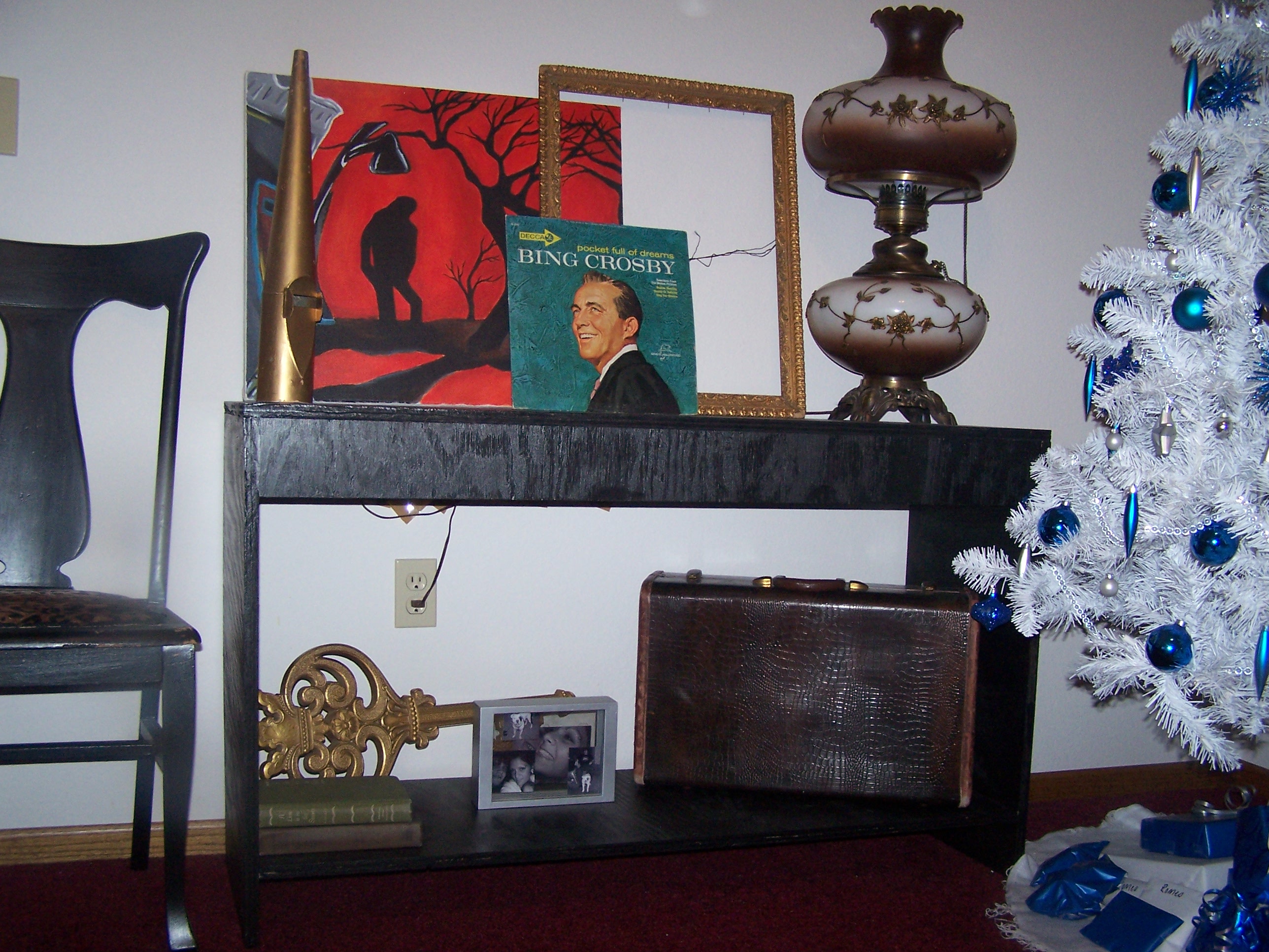 This is the close up of the table that Tony made.  The lamp is an antique from my Grandparents.  The red painting is another original by Ryan Foster.  Some other random fun odds and ends up there too.  