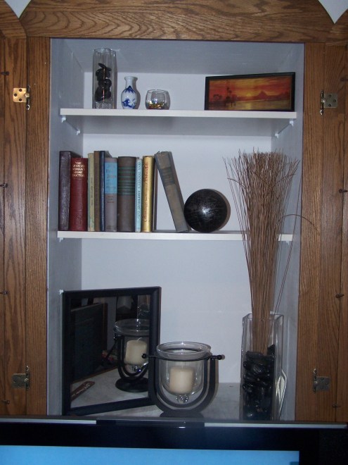 The close up of the TV cubbie.  I love the little antique picture.  In the small jar is also small little glass candies.  I need to find a better place for them.