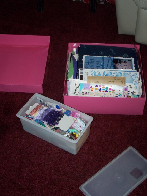 Here are just a couple of my unruly boxes of scrapbooking materials.  I love the pink box, as it is an oversized gift box from Victoria's Secret, but the heavy materials are starting to demolish the box!