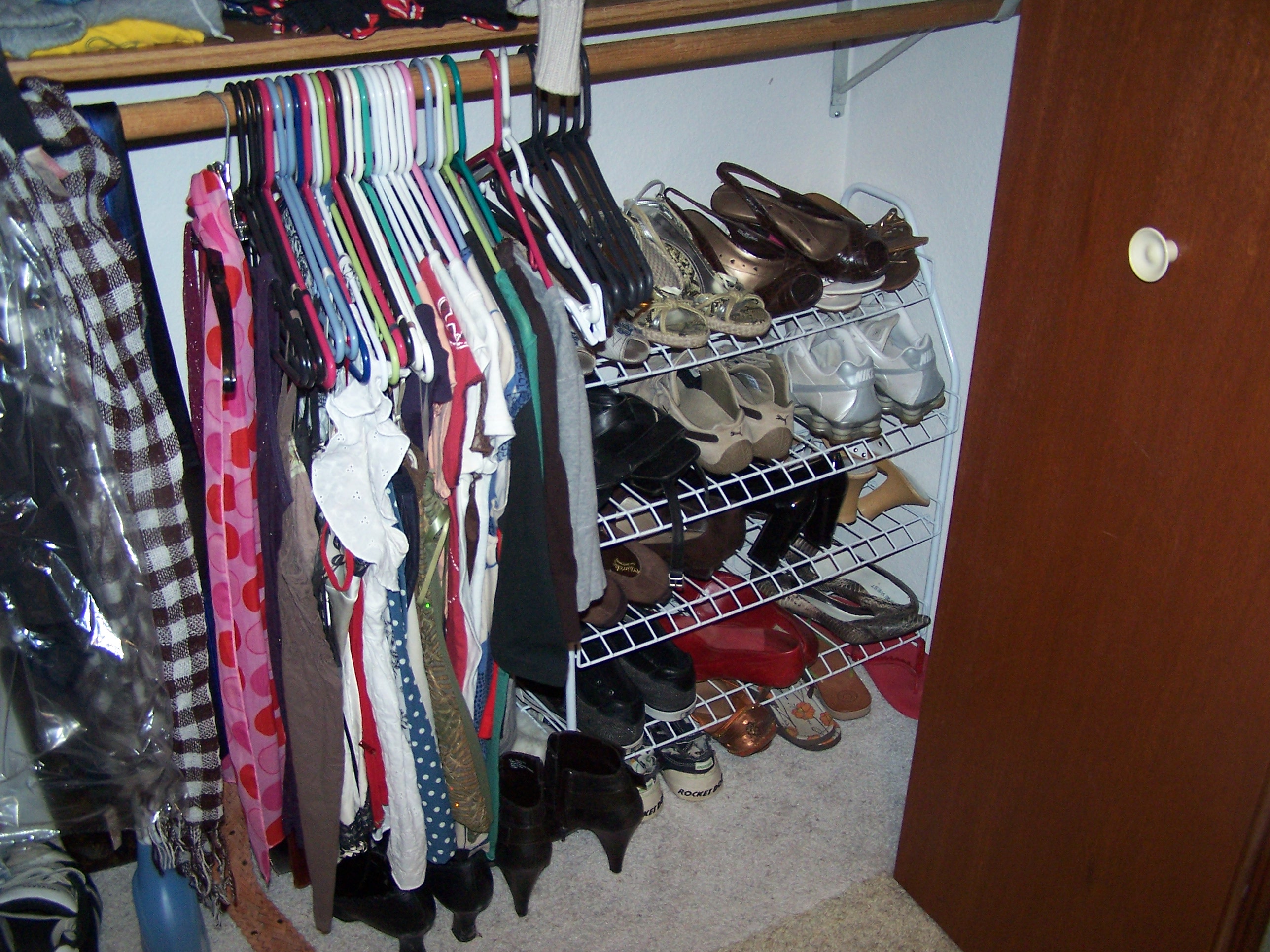 We hang belts, scarves, and ties on the low bar, along with a few of my shorter shirts.  My giant shoe rack fits in the corner.  