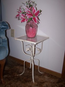 One of two old plant stands used as bedside tables in our guest room.  