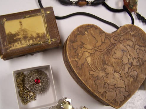 Two old jewelry boxes and a sweet locket.